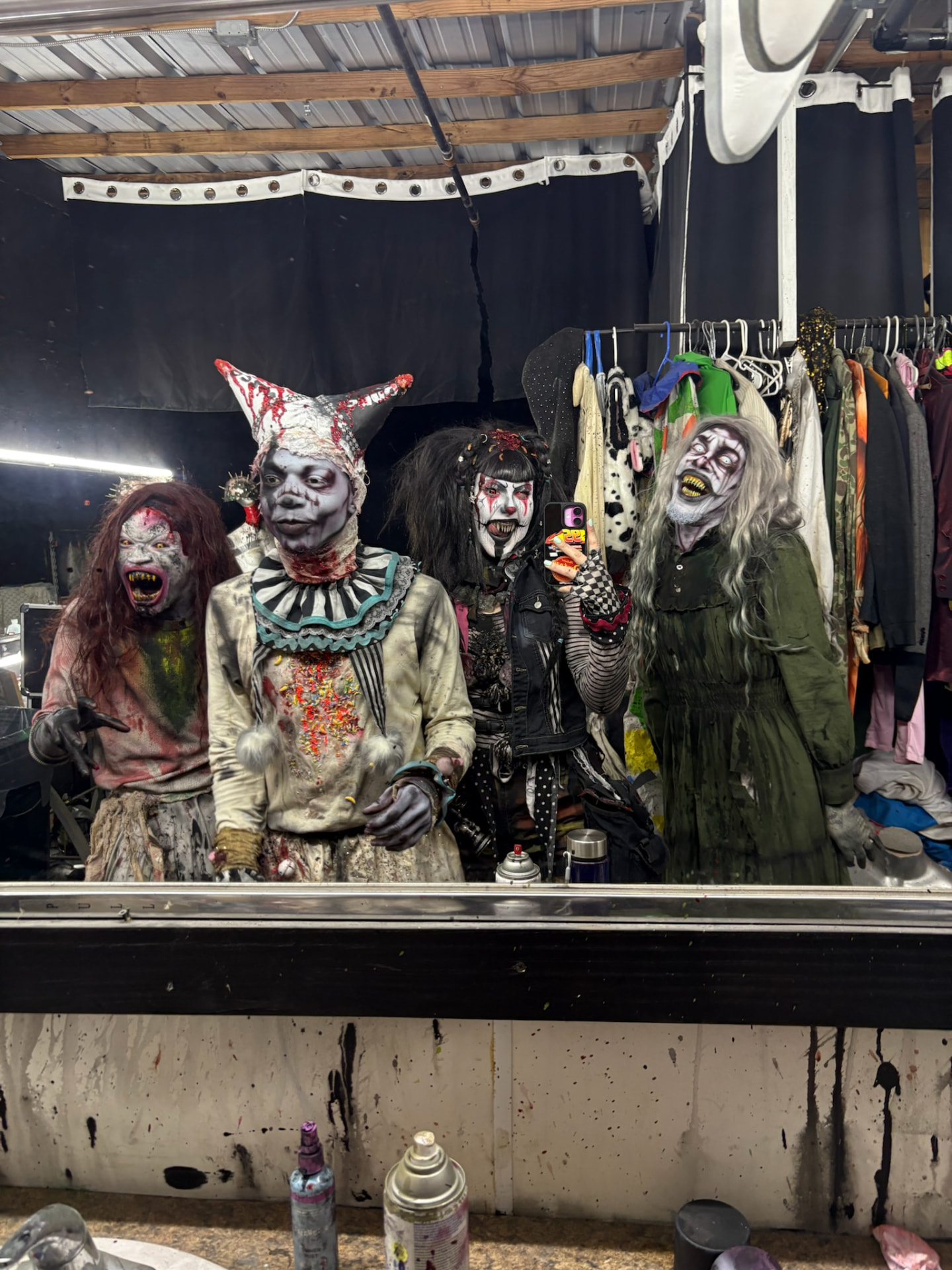 The cast taking a mirror selfie in the dressing room at Phobia Haunt