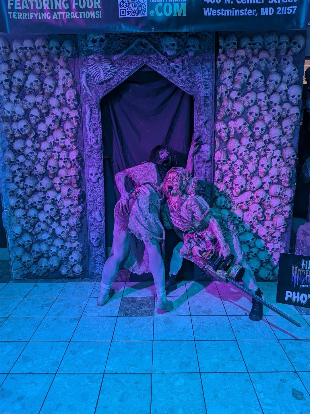 Two characters lunging at the skull-wall entrance of Hera's Nightmare in Westminster