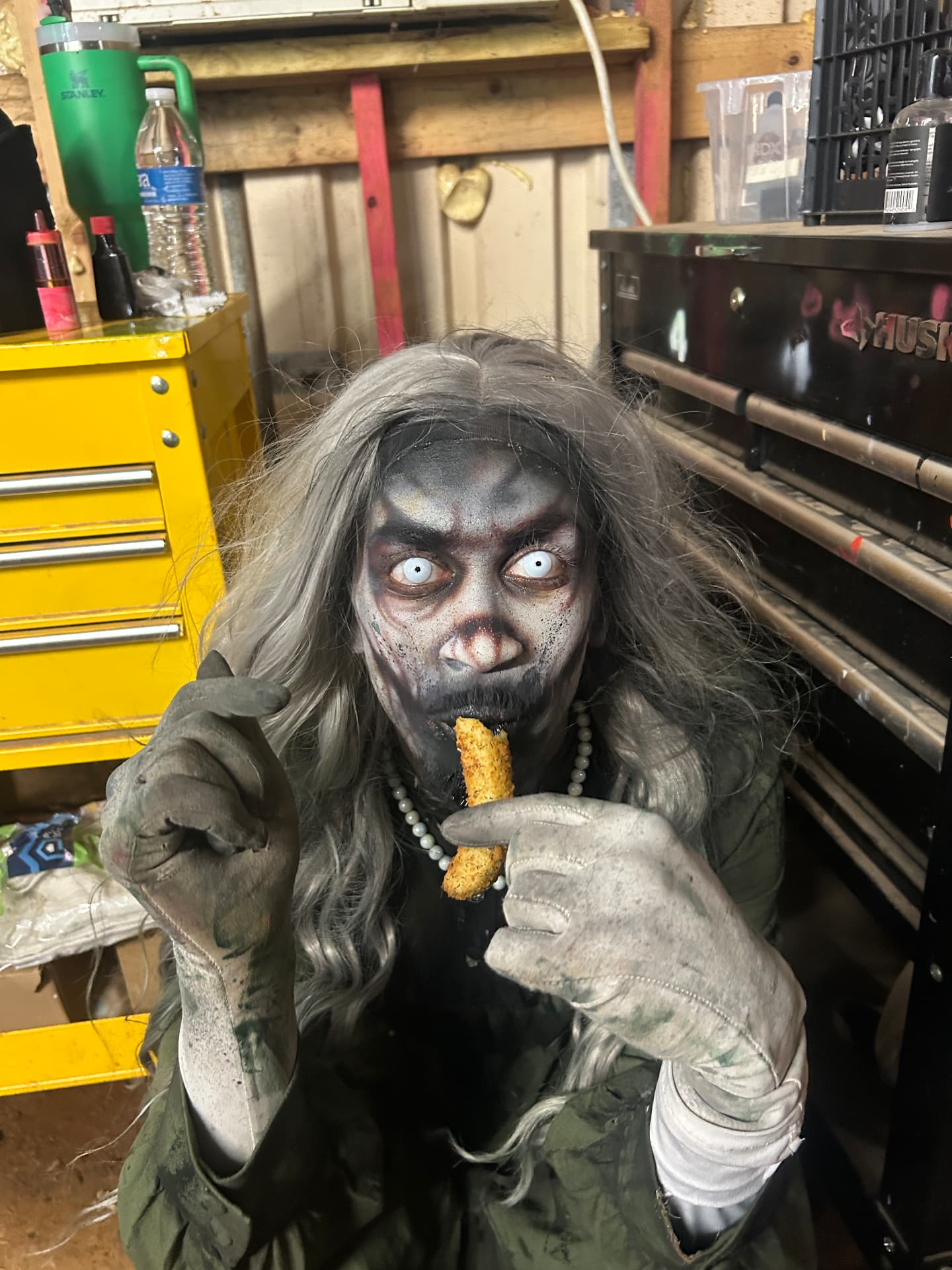 Vanity sneaking a snack backstage between scares at Scream Hollow