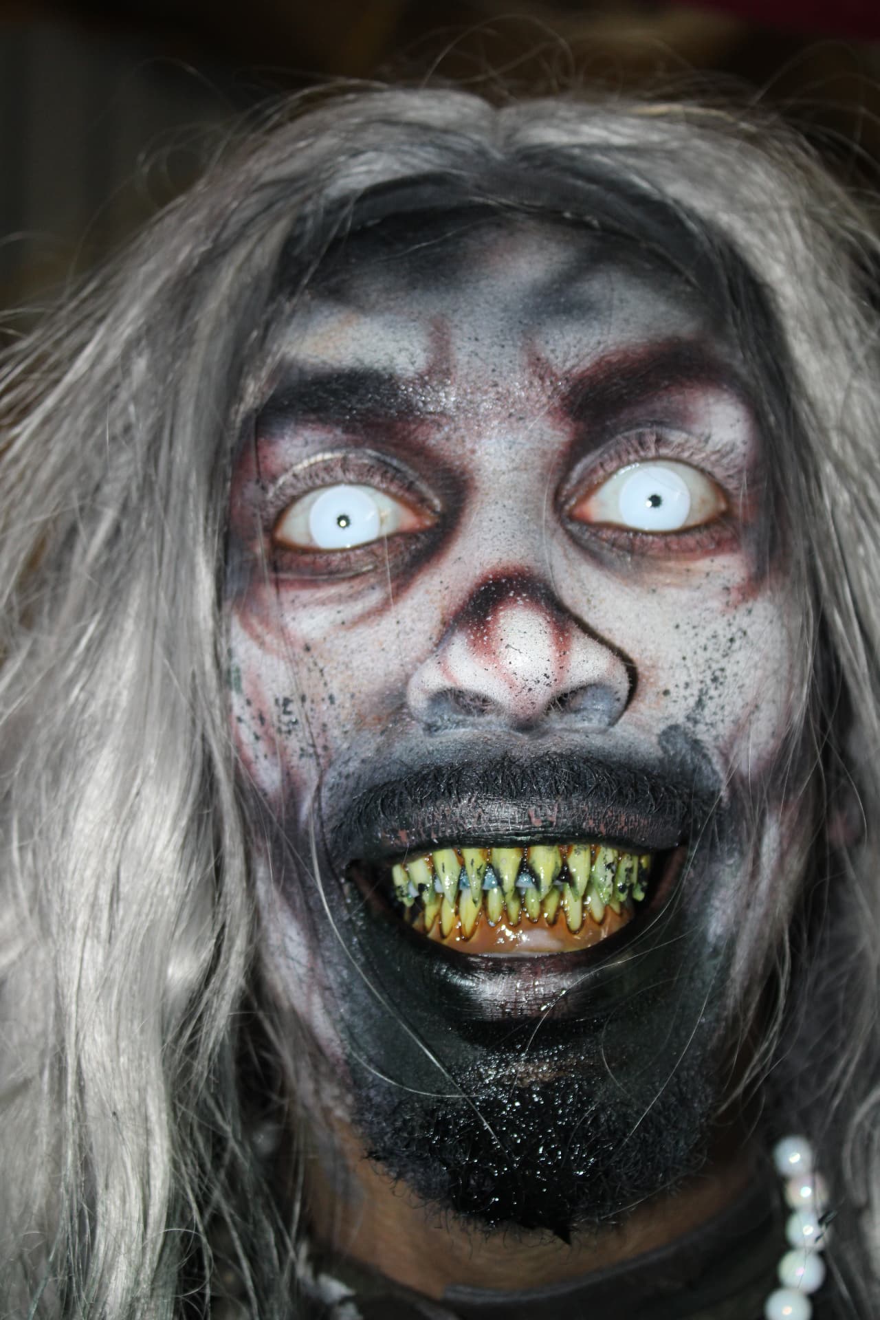 Vanity grinning at the camera in an extreme close-up at Scream Hollow