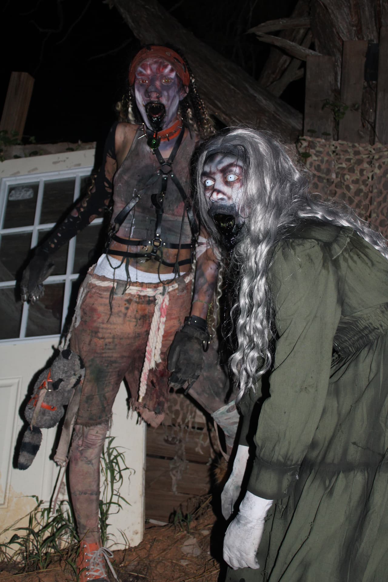 Vanity and Lucy Scroo scaring outside at night at Scream Hollow