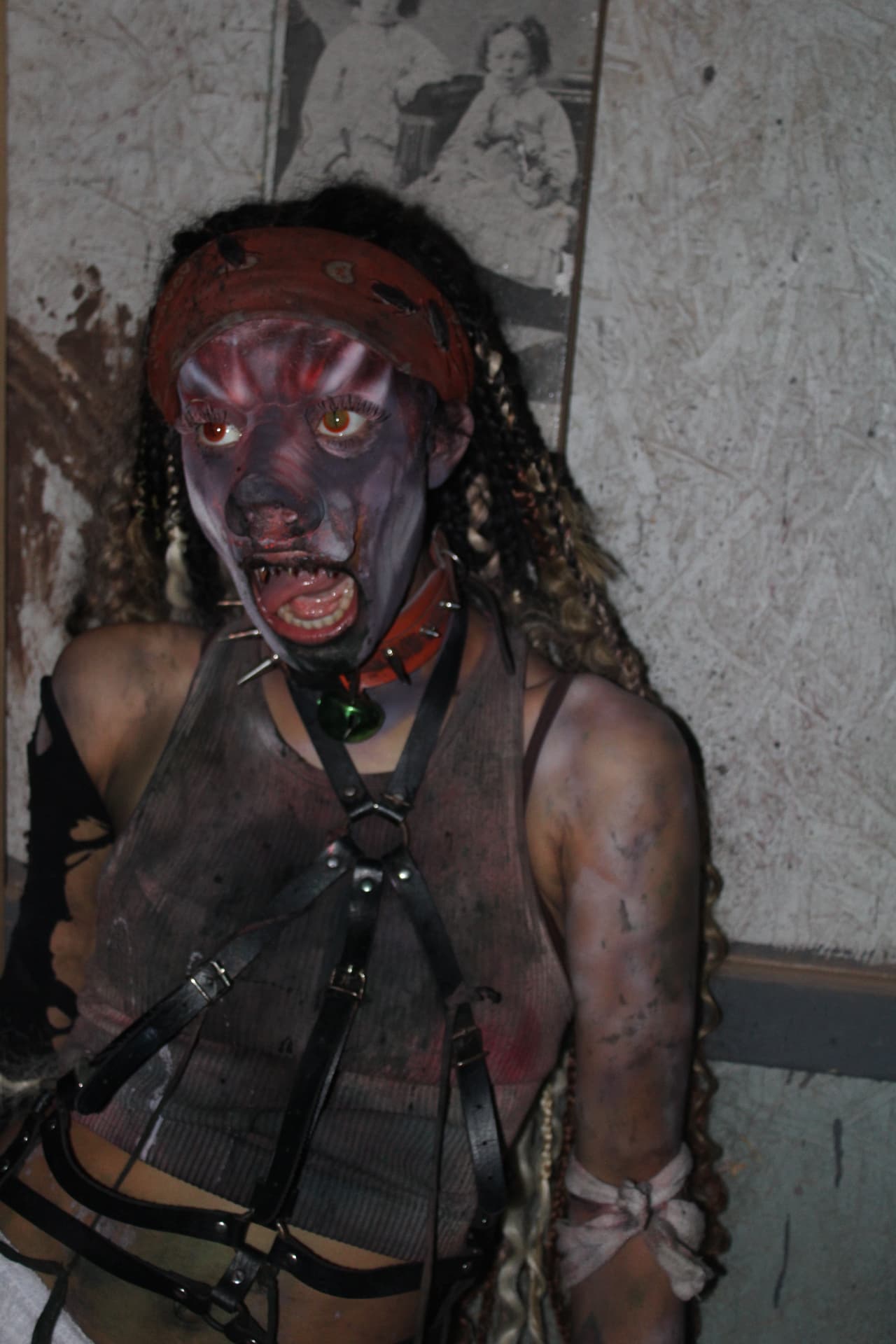 Lucy Scroo posing against a stained wall at Scream Hollow