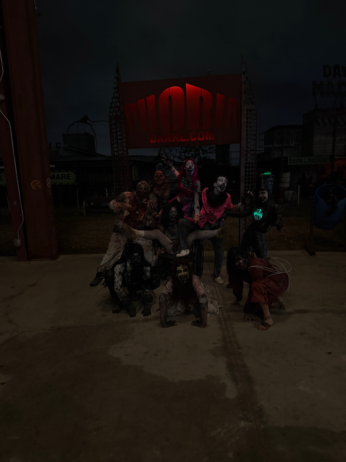 The cast posing under the Phobia sign at night